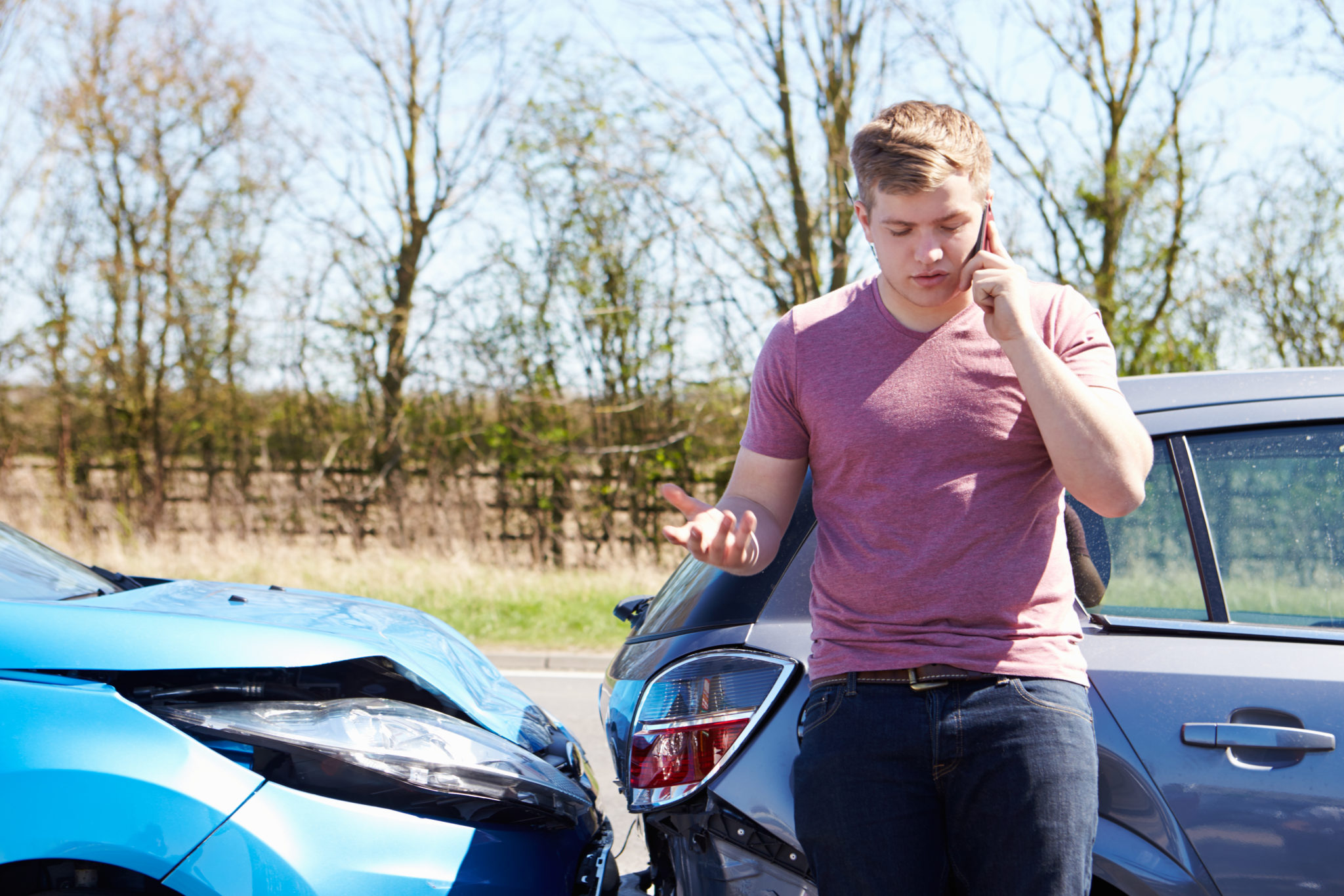 Male driver making a phone call after a car accident